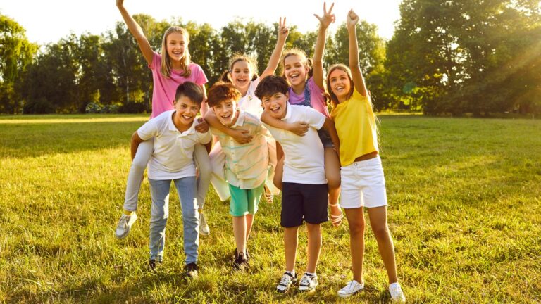 Happy,Children,Friends,Standing,Together,Outdoors,,Having,Fun,And,Smiling